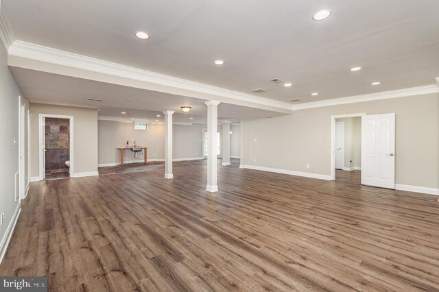 unfurnished living room featuring crown molding, decorative columns, and dark hardwood / wood-style flooring