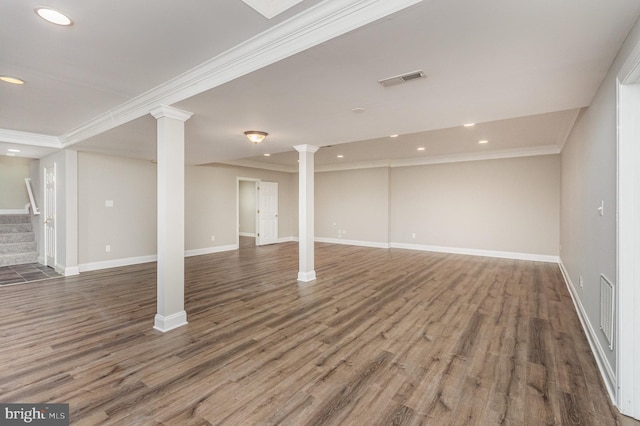 interior space with dark hardwood / wood-style flooring, decorative columns, and crown molding