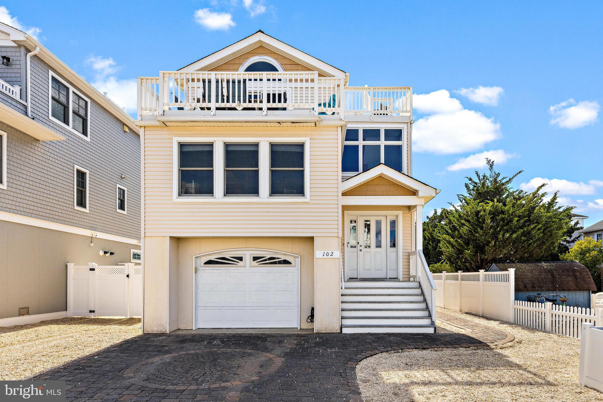 view of front of home featuring a garage and a balcony