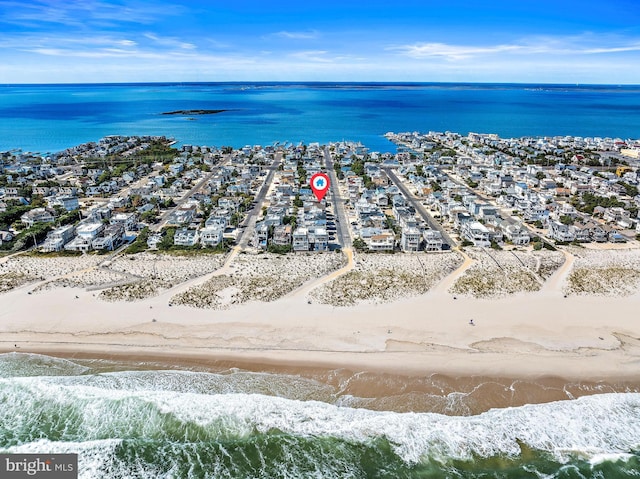 drone / aerial view featuring a view of the beach and a water view