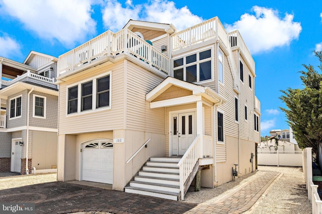 townhome / multi-family property featuring a balcony and a garage