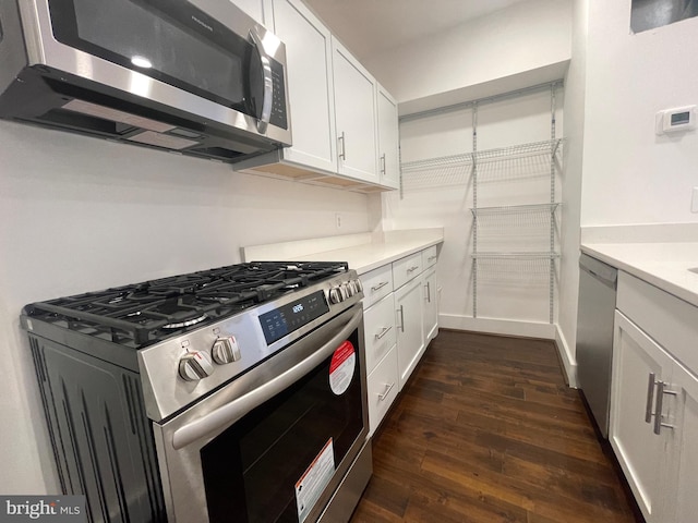 kitchen featuring white cabinetry, dark hardwood / wood-style floors, and stainless steel appliances