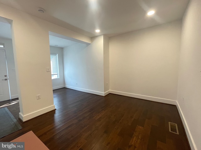 spare room with dark hardwood / wood-style flooring