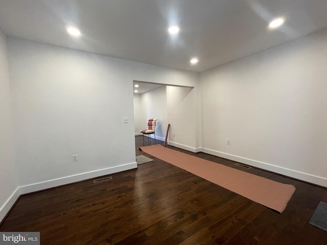 unfurnished room with dark hardwood / wood-style flooring