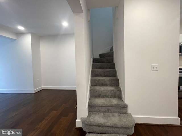 stairs featuring hardwood / wood-style flooring