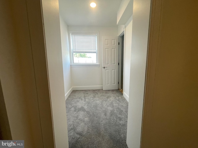 hallway with light colored carpet