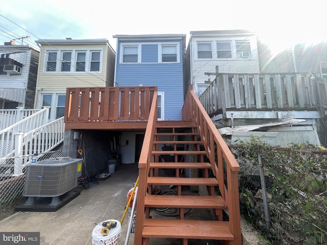 rear view of house featuring a deck and central air condition unit