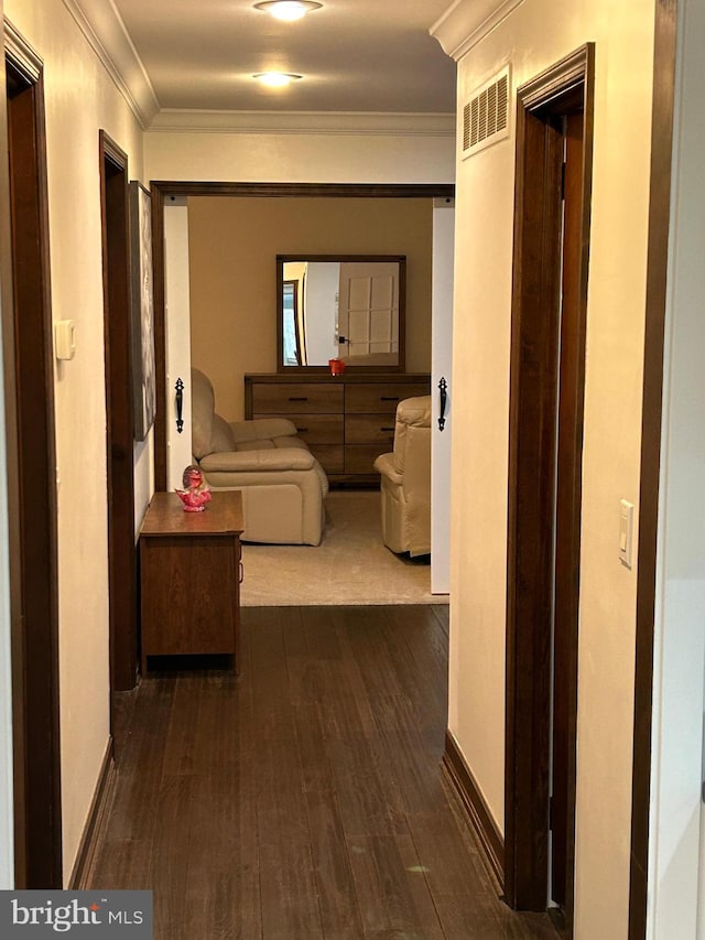 hall featuring crown molding and dark wood-type flooring