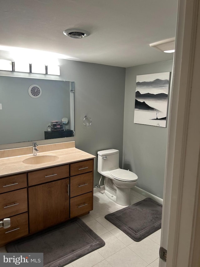 bathroom with vanity, toilet, and tile patterned floors