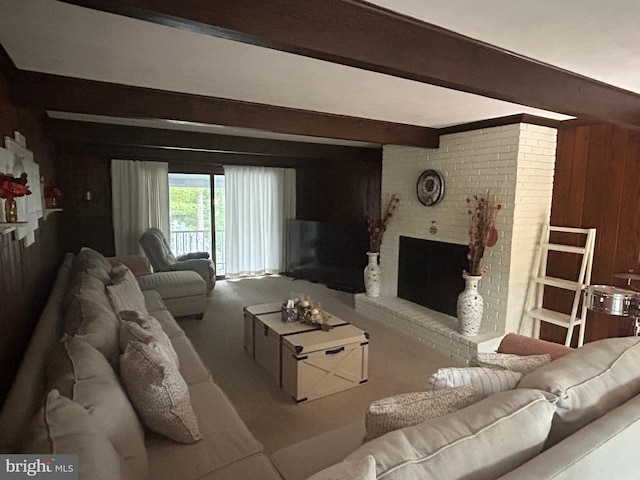 living room featuring a brick fireplace, beamed ceiling, and wood walls