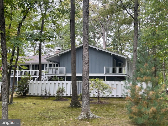 view of side of home with a yard