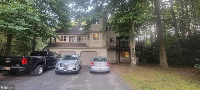 view of front of home featuring a balcony and a garage