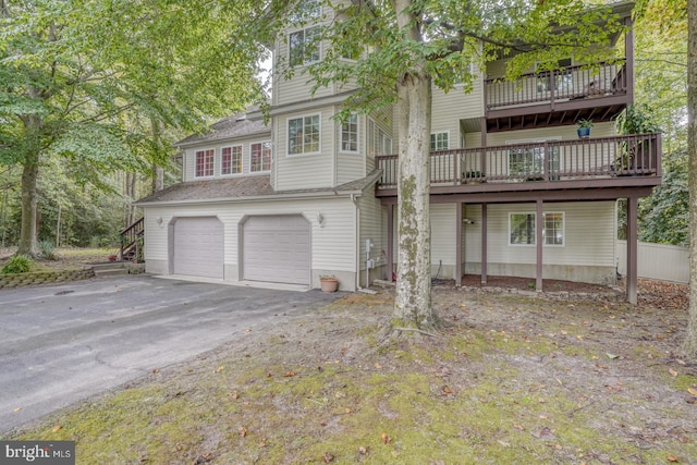 exterior space with a garage and a wooden deck