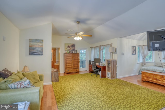 living room featuring ceiling fan, lofted ceiling, and light hardwood / wood-style floors