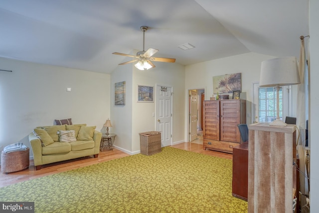 living room with ceiling fan, vaulted ceiling, and hardwood / wood-style floors