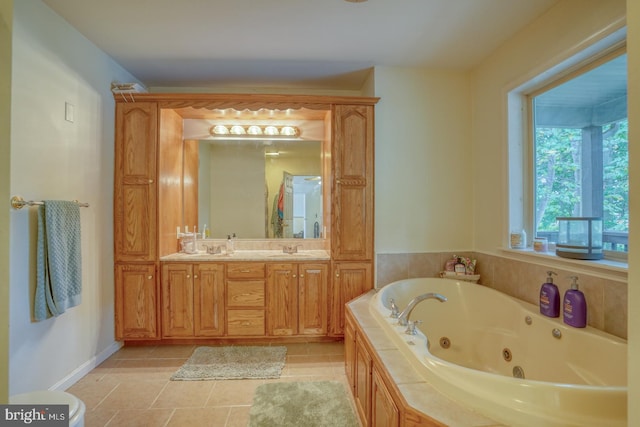 bathroom featuring a relaxing tiled tub, tile patterned flooring, and vanity