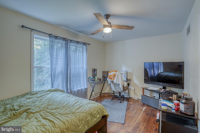 bedroom with ceiling fan and dark hardwood / wood-style floors