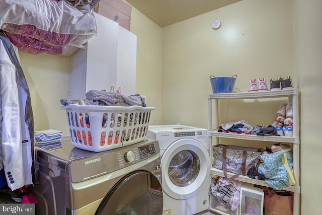 clothes washing area featuring washer and dryer