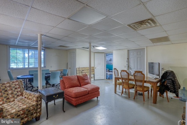 interior space with concrete flooring and a drop ceiling