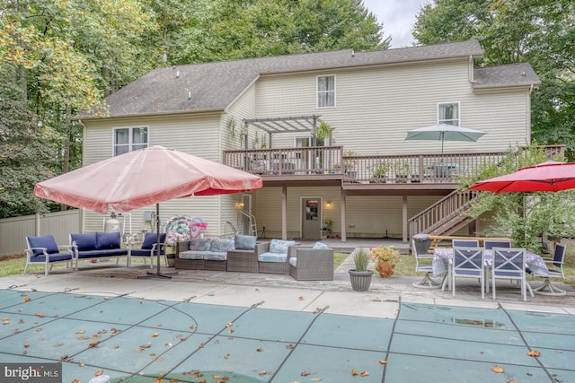 rear view of house featuring a pool side deck, an outdoor living space, and a patio area