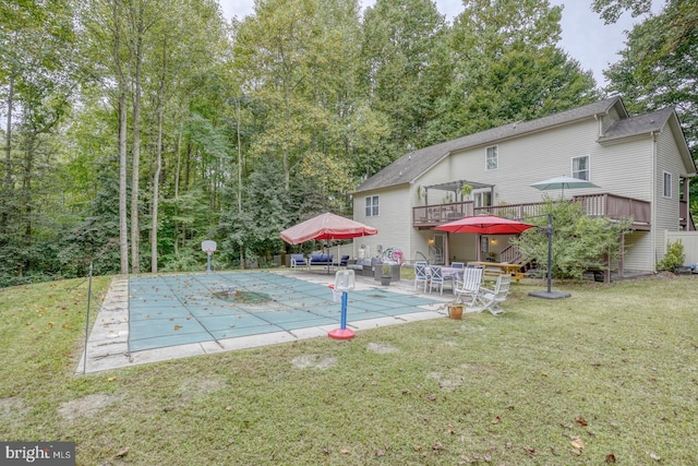 view of yard with a pool side deck and a patio area