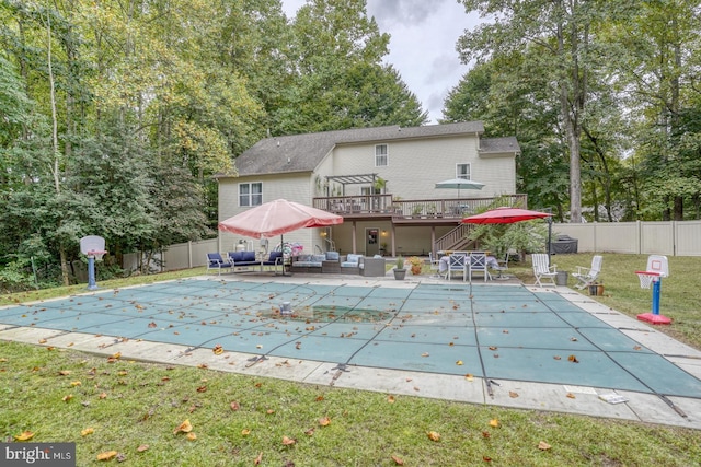 view of pool with a lawn, an outdoor hangout area, and a deck