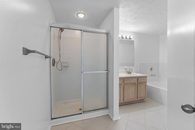 bathroom with tile patterned flooring, a textured ceiling, vanity, and separate shower and tub