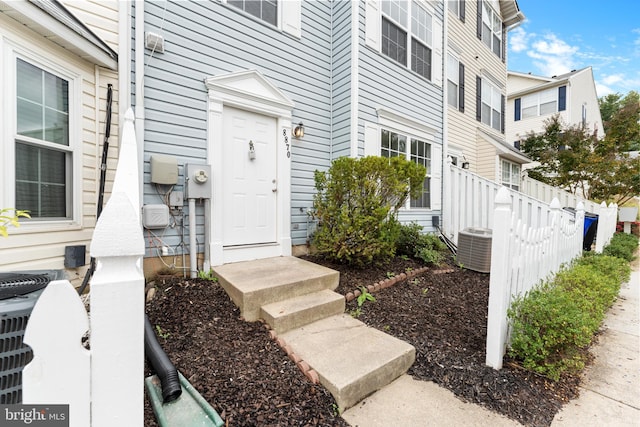 doorway to property featuring cooling unit