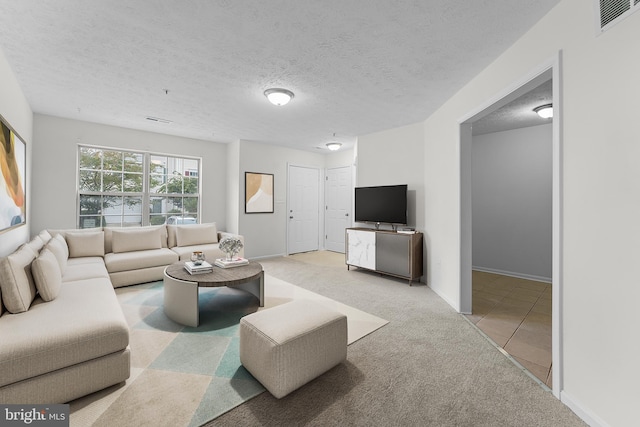 carpeted living room featuring a textured ceiling