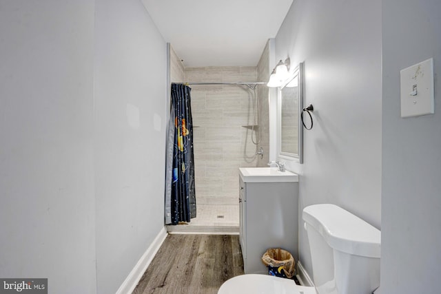 bathroom with toilet, vanity, walk in shower, and wood-type flooring