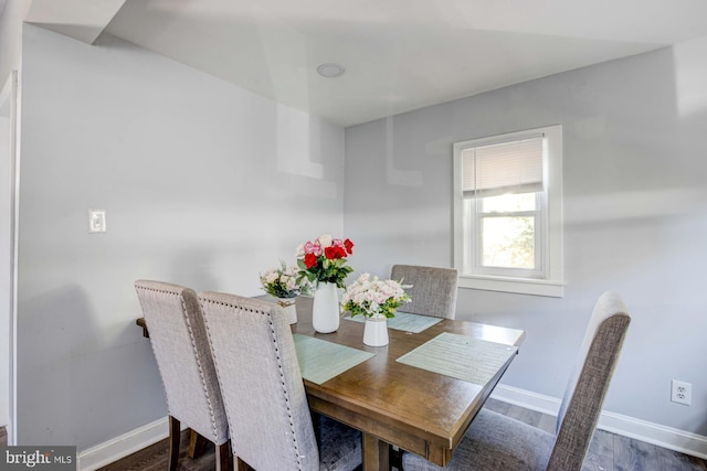 dining space with dark wood-type flooring