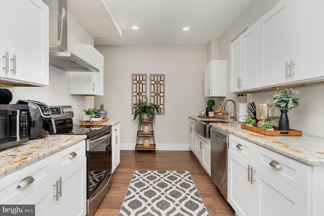 kitchen featuring white cabinetry, wall chimney exhaust hood, stainless steel appliances, dark hardwood / wood-style floors, and sink