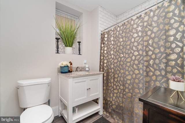 bathroom featuring hardwood / wood-style flooring, vanity, and toilet