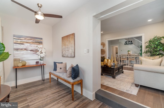 living area featuring wood-type flooring and ceiling fan