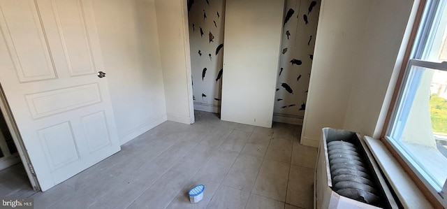 unfurnished bedroom featuring baseboards and light wood-type flooring