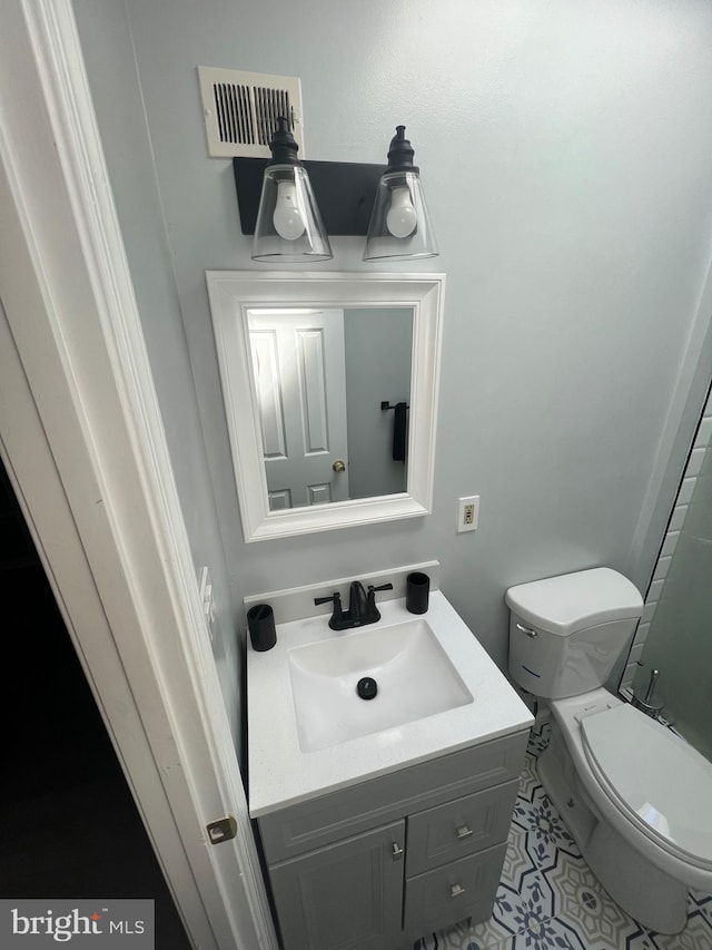 bathroom featuring vanity and toilet