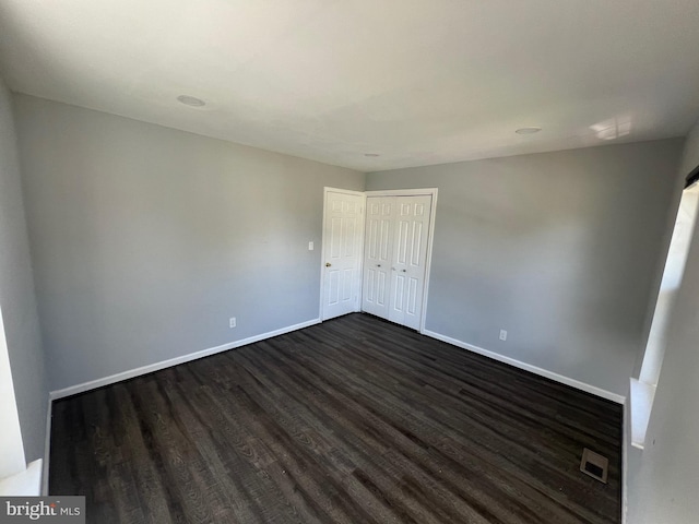 unfurnished bedroom with dark hardwood / wood-style floors