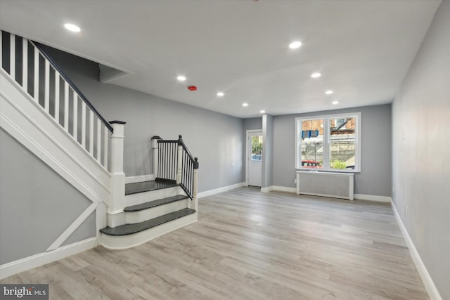 foyer featuring radiator and light hardwood / wood-style floors