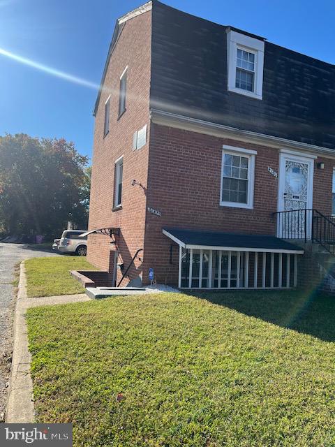 rear view of house with a yard