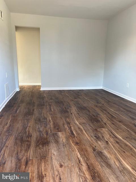 spare room featuring dark hardwood / wood-style flooring