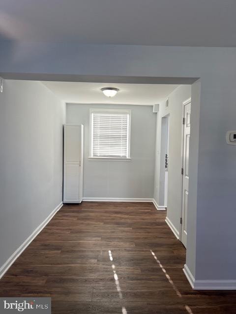 corridor featuring dark wood-type flooring