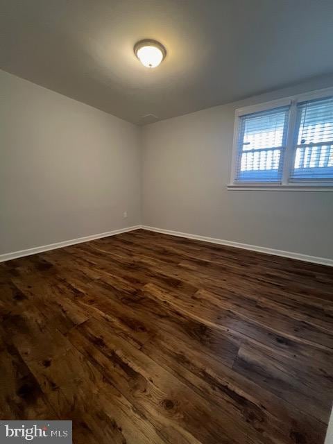 empty room with dark hardwood / wood-style floors