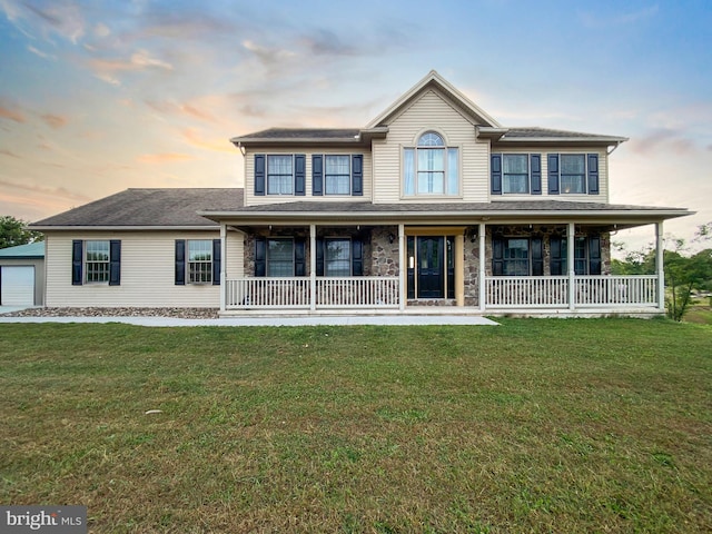 view of front facade with a porch and a yard