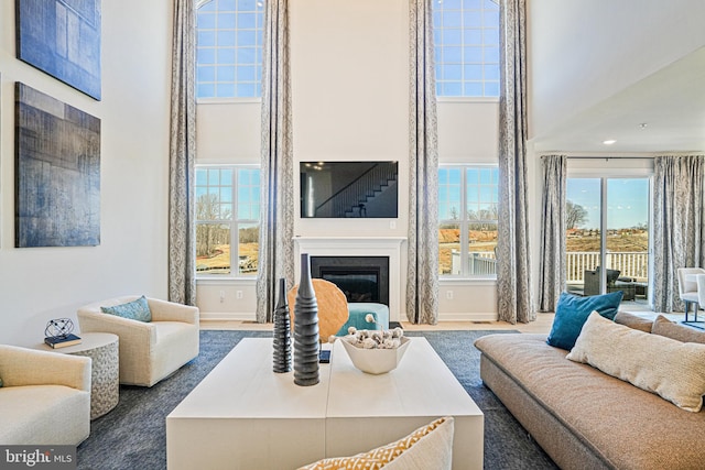 living room with carpet floors and a high ceiling