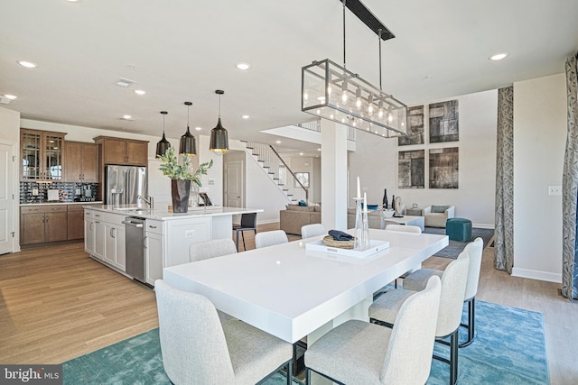 dining area with light wood-type flooring and sink