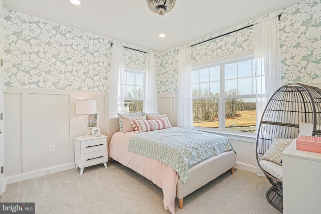 carpeted bedroom featuring multiple windows