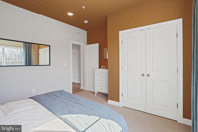 carpeted bedroom featuring a closet