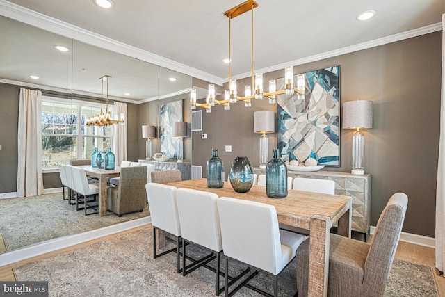 dining area with hardwood / wood-style floors and ornamental molding