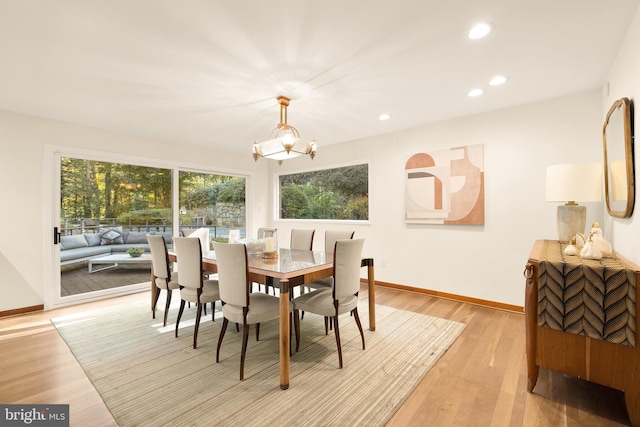 dining room with a notable chandelier and light hardwood / wood-style flooring