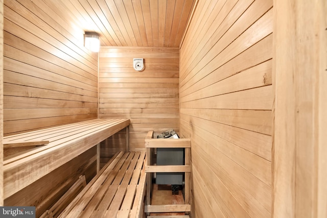 view of sauna / steam room featuring wood walls and wooden ceiling